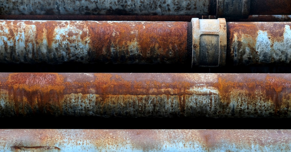 Water pipelines attached to a building damaged by rust and corrosion.